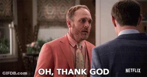 A Man In A Suit Says Oh Thank God GIF