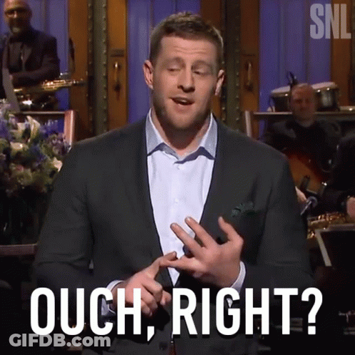 A Man In A Suit Says Ouch Right In Front Of A Band GIF