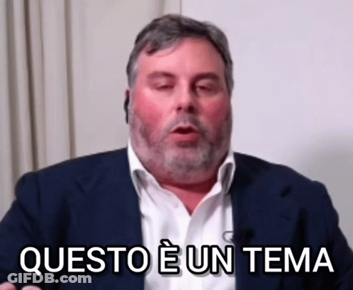 A Man In A Suit Says Questo E Un Tema In A Foreign Language GIF