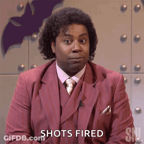 A Man In A Suit Says Shots Fired GIF