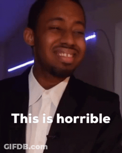 A Man In A Suit Says " This Is Horrible " In Front Of Him GIF