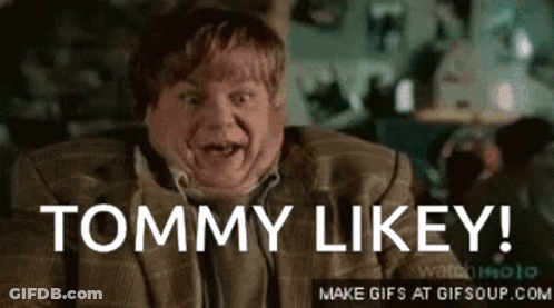 A Man In A Suit Says " Tommy Likey " In Front Of His Face GIF