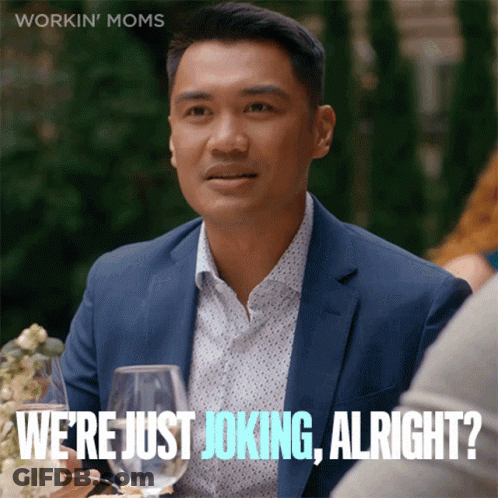 A Man In A Suit Says " We 'Re Just Joking Alright " While Sitting At A Table With Wine Glasses GIF