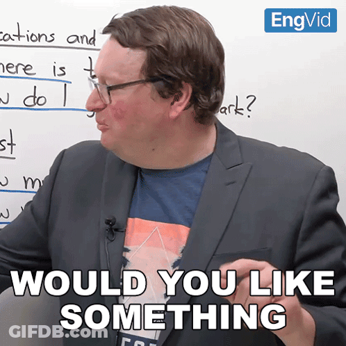 A Man In A Suit Says " Would You Like Something " In Front Of A Whiteboard GIF