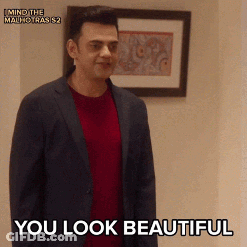 A Man In A Suit Says You Look Beautiful In Front Of A Framed Picture GIF