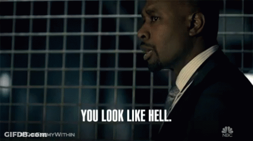 A Man In A Suit Says " You Look Like Hell " In Front Of A Nbc Logo GIF
