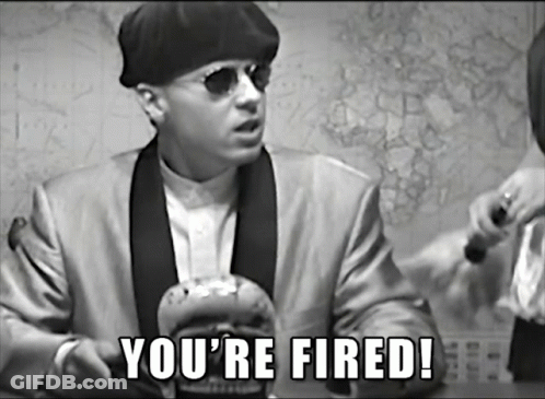 A Man In A Suit Says You 'Re Fired In A Black And White Photo GIF