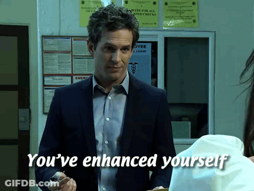 A Man In A Suit Says You 'Ve Enhanced Yourself In Front Of A Bulletin Board GIF