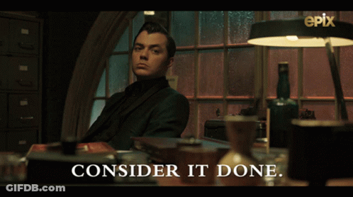 A Man In A Suit Sits At A Desk With The Words " Consider It Done " Above Him GIF