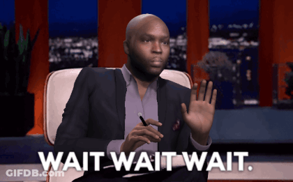 A Man In A Suit Sits In A Chair With The Words Wait Wait Wait Below Him GIF