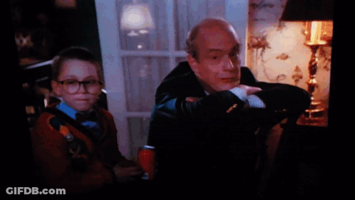 A Man In A Suit Sits Next To A Boy In A Sweater GIF