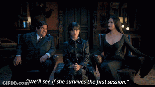 A Man In A Suit Sits Next To Two Women And Says " We 'Ll See If She Survives The First Session " In Front Of Them GIF