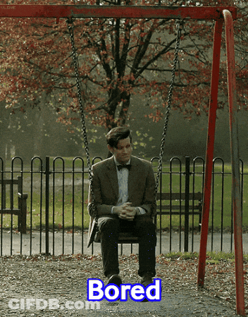 A Man In A Suit Sits On A Swing With The Word Bored Below Him GIF
