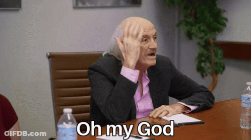 Man In Suit Sitting At Table With Oh My God GIF