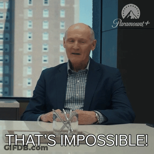 A Man In A Suit Sitting At A Table With The Words That 'S Impossible GIF