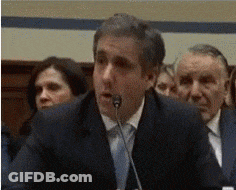 A Man In A Suit Speaking Into A Microphone GIF