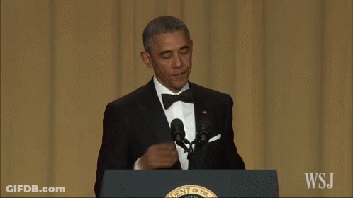 A Man In A Suit Stands At A Podium That Says Wsj On It GIF