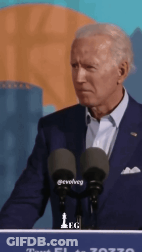 A Man In A Suit Stands At A Podium With The Word Evolveg On The Front GIF