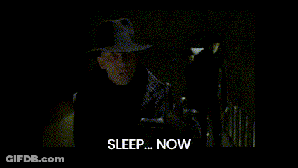A Man In A Suit Stands In A Dark Room And Says Sleep Now GIF
