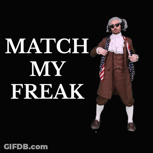 A Man In A Suit Stands In Front Of A Black Background With The Words Match My Freak GIF