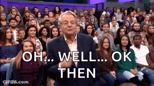 A Man In A Suit Stands In Front Of A Crowd Of People And Says " Oh Well Ok Then " . GIF
