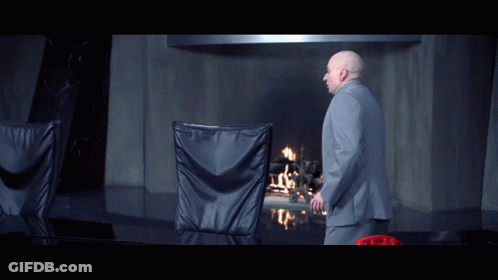 A Man In A Suit Stands In Front Of A Fireplace With The Words There 'S Nothing More Pathetic Than An Aging Hipster GIF