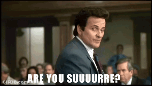A Man In A Suit Stands In Front Of A Group Of People And Says Are You Suuuurre GIF