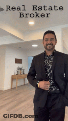 Man In Suit In Front Of Real Estate Broker Sign GIF