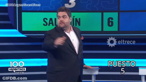 A Man In A Suit Stands In Front Of A Screen That Says 100 Argentinas Dicen GIF