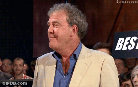 A Man In A Suit Stands In Front Of A Sign That Says Best On It GIF