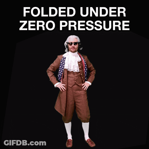 A Man In A Suit Stands In Front Of A Sign That Says " Folded Under Zero Pressure " GIF
