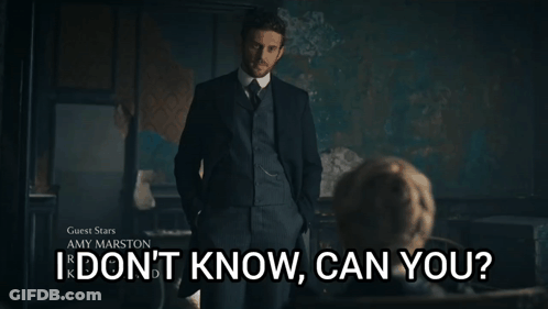 A Man In A Suit Stands In Front Of A Sign That Says Guest Stars Amy Marston I Don 'T Know Can You GIF