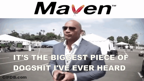 A Man In A Suit Stands In Front Of A Sign That Says " Maven " GIF