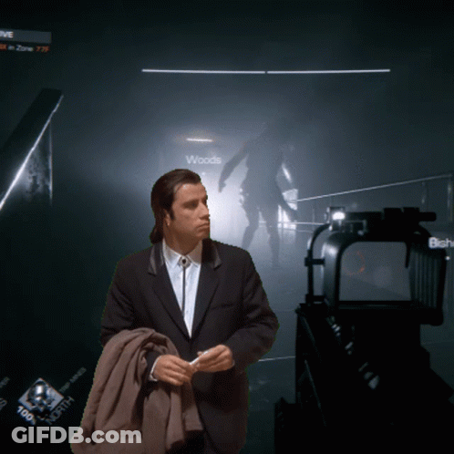 A Man In A Suit Stands In Front Of A Sign That Says " Woods " GIF