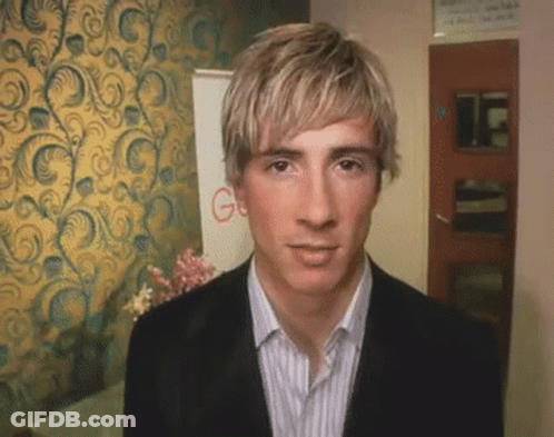 A Man In A Suit Stands In Front Of A Wall With A Google Sign GIF