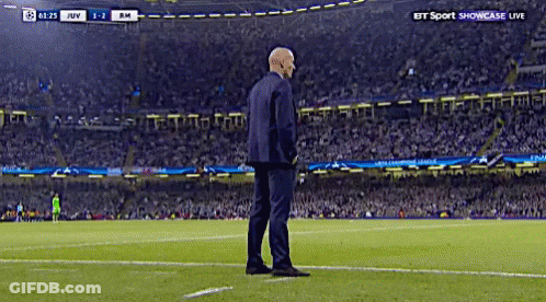 A Man In A Suit Stands On A Soccer Field During A Bt Sport Showcase Live Match GIF