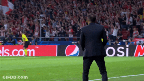 A Man In A Suit Stands On A Soccer Field In Front Of An Advertisement For Pepsi GIF