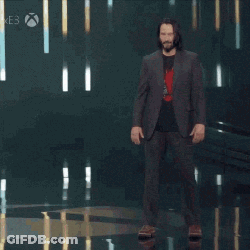 A Man In A Suit Stands On A Stage With The Words You 'Re Breathtaking Behind Him GIF