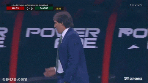 A Man In A Suit Talks On A Cell Phone In Front Of A Power Ad Sign GIF