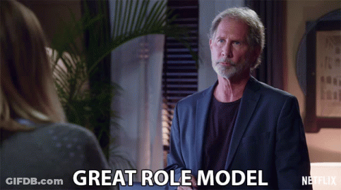 A Man In A Suit Talks To A Woman And Says " Great Role Model " GIF