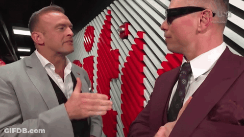A Man In A Suit Talks To Another Man In A Suit GIF