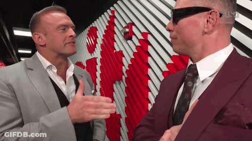 A Man In A Suit Talks To Another Man In A Suit GIF