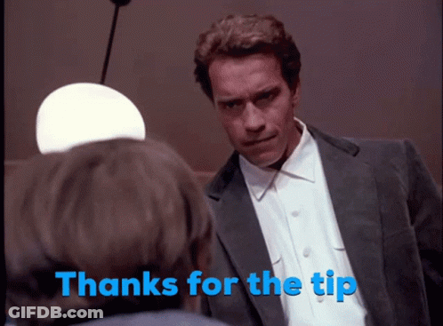 A Man In A Suit Talks To Another Man With The Words Thanks For The Tip Behind Him GIF
