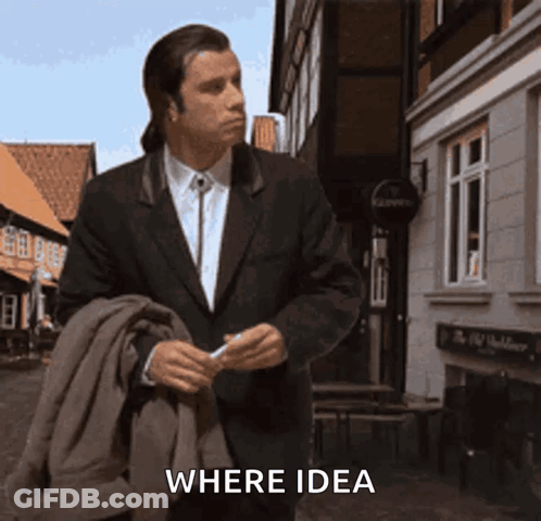 A Man In A Suit Walking Down A Street With The Word Where Idea Written On The Bottom GIF