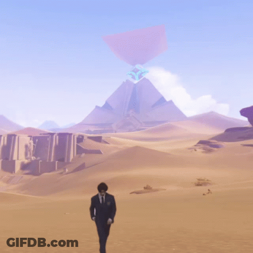A Man In A Suit Walks Through A Desert With A Mountain In The Background GIF