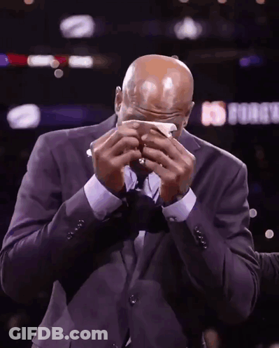 A Man In A Suit Wipes His Face With A Napkin In Front Of A Sign That Says ' Nba Force ' GIF