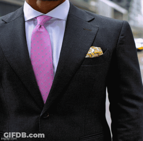 A Man In A Suit With A Pink Tie And Pocket Square GIF