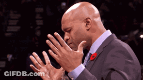 A Man In A Suit With A Red Poppy On His Lapel GIF