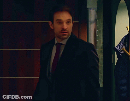 A Man In A Suit With A Red Tie Looks Surprised GIF