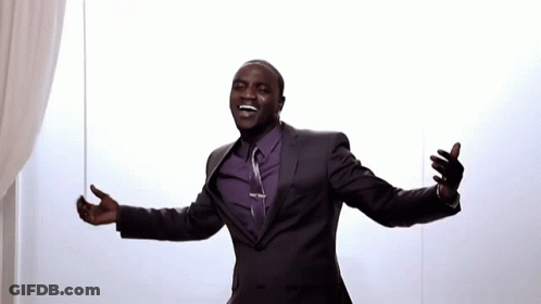 A Man In A Suit With His Arms Outstretched GIF